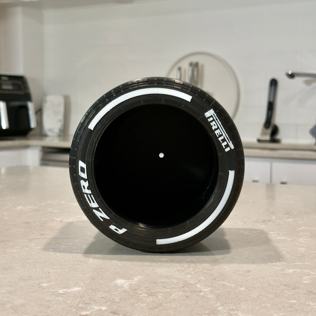 Black tire on a kitchen counter with a white background